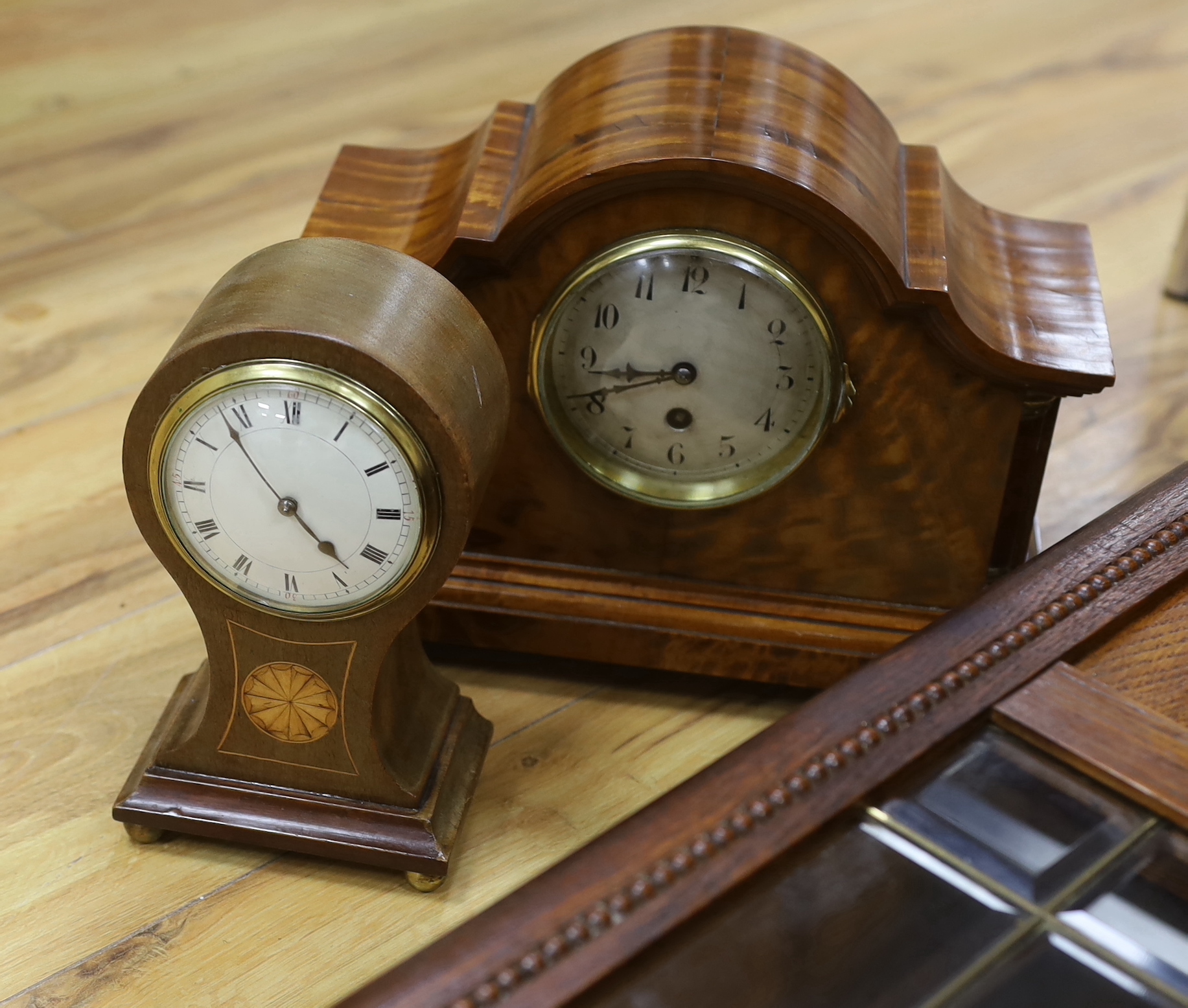 Two mantel clocks including an Edwardian inlaid balloon example and a wall clock, largest 80cm high